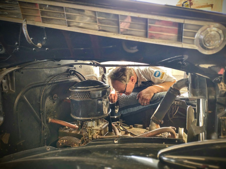 Mechanic inspecting a car under the hood