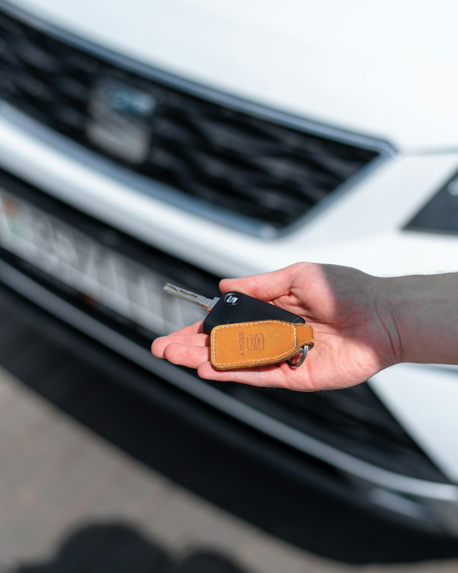 Seller handing over a car key at the curb during a cash pickup